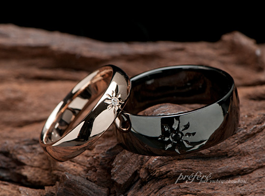 太陽モチーフの結婚指輪 ピンクゴールドの甲丸に白いダイヤ ブラック仕上げの巾広甲丸形状にはブラックダイヤ